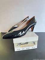 Side view of both pumps on box showing profile, heel height and box label