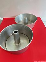 Both pans upright showing interior and tubes