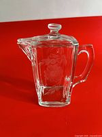 Front view of lidded creamer showing Corn Flower etching