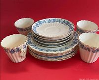 Group shot of all 14 pieces showing cups, saucers and plates