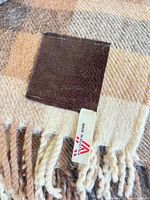 Blanket label showing Made in Austria tag and fringe