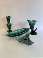 Front view of all four green-teal ceramic pieces