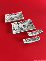 Top view of complete set showing pattern on two dishes and two rests