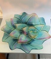 Top view of entire teal iridescent floral glass bowl