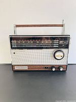 Front view showing entire Longines Symphonette World Traveler radio with handle