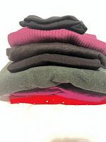 Stack of folded sweaters showing colour range