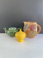 Front view of pitcher, teapot and sugar bowl