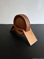 Coasters stacked in holder side view