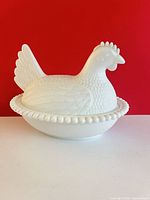 Left profile view of assembled hen on nest dish