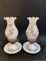 Full view of both matching milk glass hurricane lamps