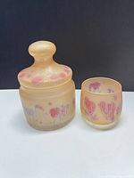 Jar with lid and tumbler side by side showing color and motif