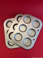Three stacked 6-cup aluminum pans showing overall design and quantity