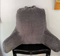Front view of gray ribbed plush reading pillow showing arms and overall shape