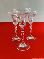 Three clear glass stemmed candle holders front view