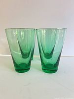 Front view of four green tumblers