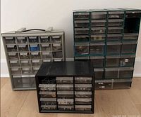 Three multi-drawer organizers side by side