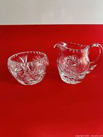 Creamer pitcher and sugar bowl front view on red background