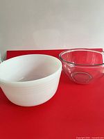 white milk glass bowl and clear glass bowl side by side