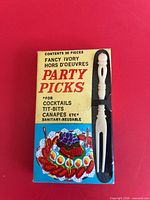 Front of box showing branding and one sample pick