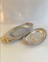 Top view of both oval trays showing size difference and gold-tone handles