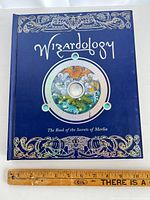 Front cover of Wizardology book with ruler for scale