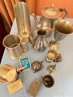 Group shot of all metalware pieces on table