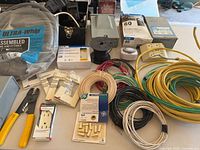 Overview of lot with wire coils, tools, timers, receptacles, Ultra-Whip package