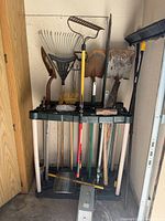 Overview of Rubbermaid rack holding assorted garden tools
