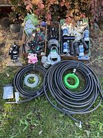 Overview showing tubing coils, PVC fittings, Rain Bird and Hunter sprinkler parts
