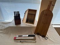 Full lot with knife block, knife case, bread knife, carving fork, cutting board on stand