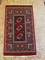 Front view of Beaulieu Bokhara area rug showing full pattern and fringes