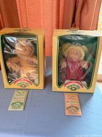 Two boxed Cabbage Patch Kids dolls with certificates