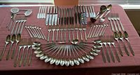 All 106 pieces laid out on table showing variety of utensils