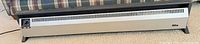Full view of HeatRite baseboard heater showing overall condition and freestanding design