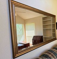 Mirror mounted on wall above sofa showing full size and orientation