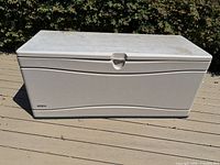 Full view of beige Lifetime deck box on deck