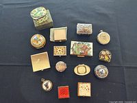 Top-down view of all small decorative boxes on black cloth