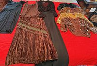 All seven garments laid out showing variety and full shapes