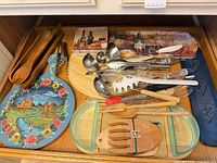 Drawer view of entire assortment showing utensils, boards, tray and glass pieces
