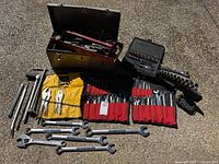 All tools and storage items spread out on ground