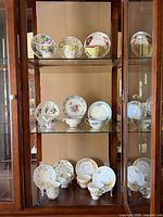 Cabinet view showing all teacup-saucer sets displayed