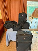 All five matching navy Ricardo Beverly Hills Westwood luggage pieces displayed together