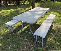 Table and two benches set up outdoors