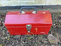 Closed red metal toolbox showing exterior condition