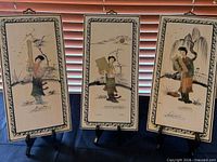 All three wooden geisha plaques on easels