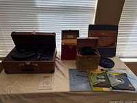 Overall lot with turntable, three record cases, vinyl records and sleeves