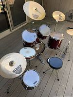 Full Premier drum kit assembled with cymbals, throne and stands on deck