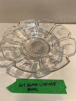 Top view of clear cut glass bowl showing scalloped rim and starburst center