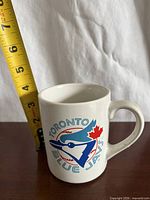 Front view of mug with Toronto Blue Jays logo and height measurement