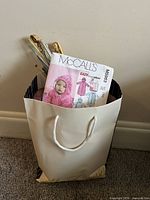 Bag showing top of knitting needles and McCall’s pattern envelope